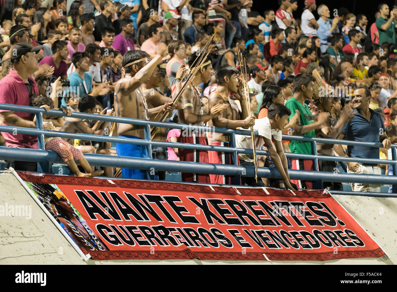 Palmas, Brazil. 30th October, 2015. Xerente warriors cheer in support of their women's team during the final of the women's football, between the local Xerente tribe and the Native American team from the USA at the International Indigenous Games in the city of Palmas, Tocantins State, Brazil. The USA won on a penalty shoot-out after a 0-0 match. Credit:  Sue Cunningham Photographic/Alamy Live News Stock Photo