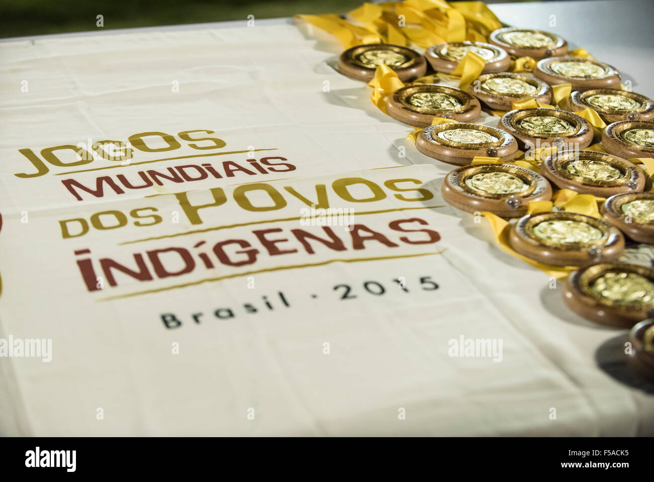 Palmas, Brazil. 30th October, 2015. Gold medals for the winners of the women's football lie on a table. The match between the local Xerente tribe and the Native American team from the USA at the International Indigenous Games in the city of Palmas, Tocantins State, Brazil was won by the USA on a penalty shoot-out after a 0-0 match. Credit:  Sue Cunningham Photographic/Alamy Live News Stock Photo