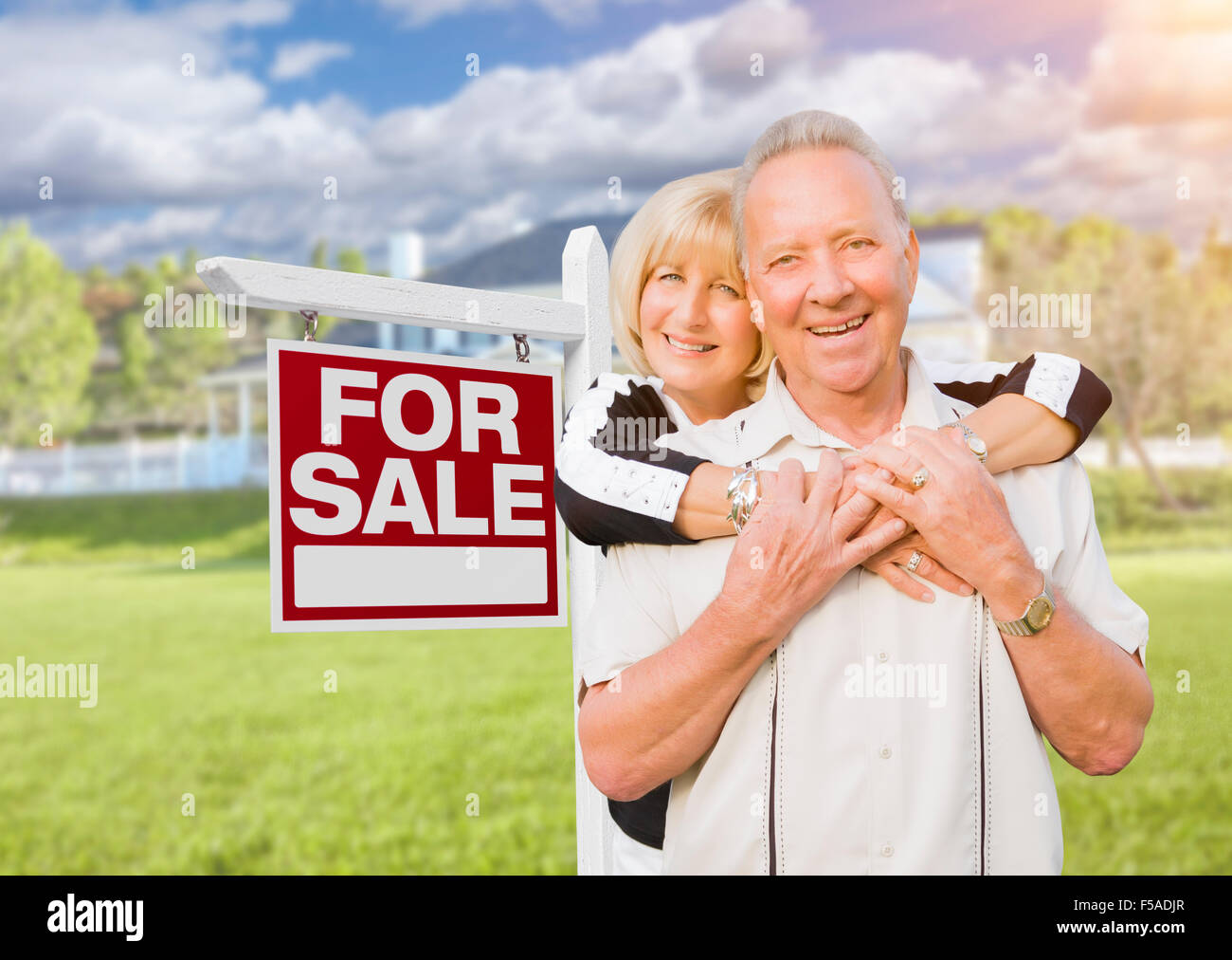 Happy Senior Couple Front of For Sale Real Estate Sign and House Stock ...