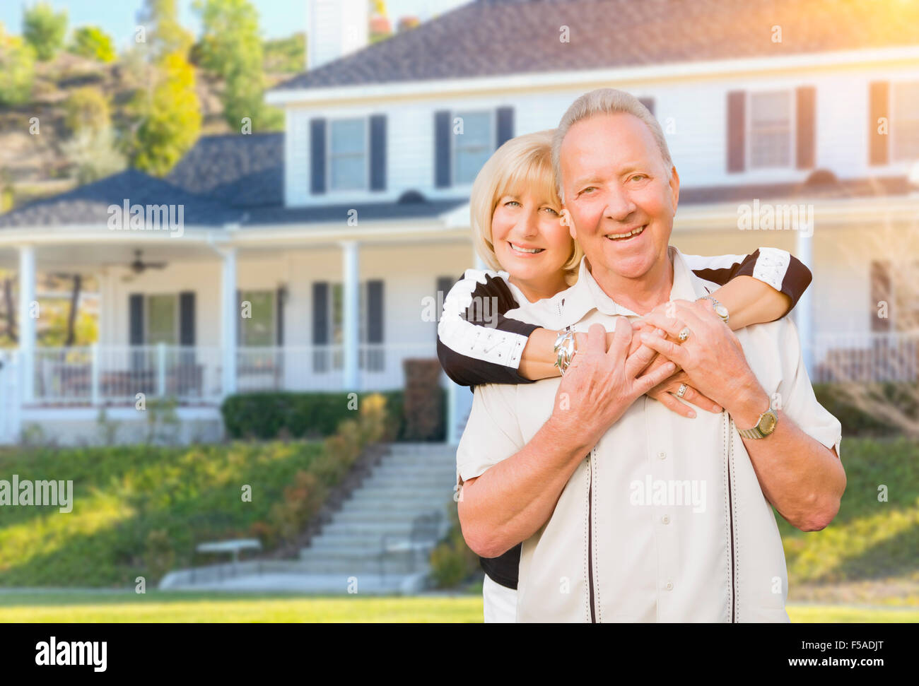 Happy Senior Couple in the Front Yard of Their House. Stock Photo