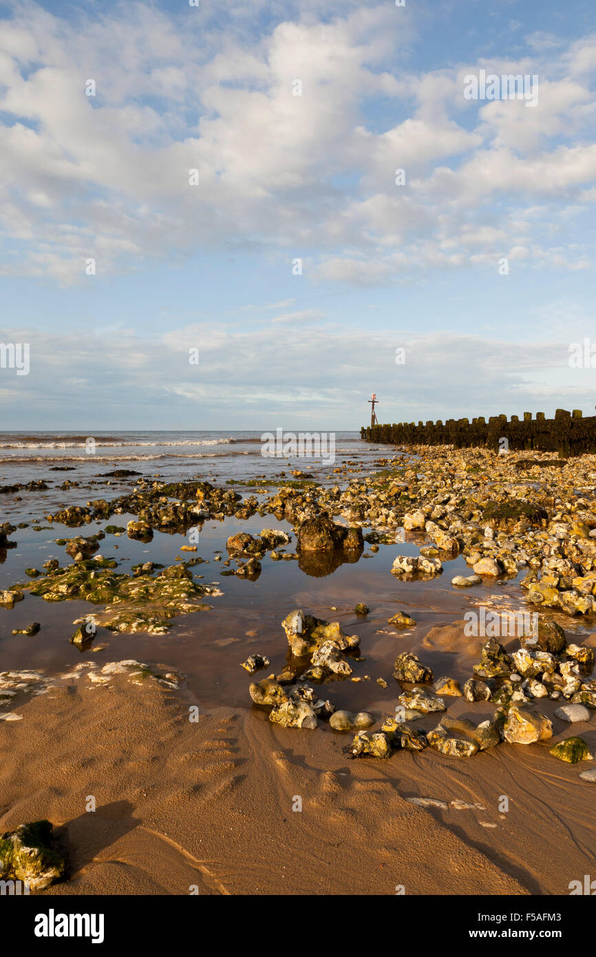 Evening at West Runton  beach UK, with a low tide showing rock pools on the beach Stock Photo