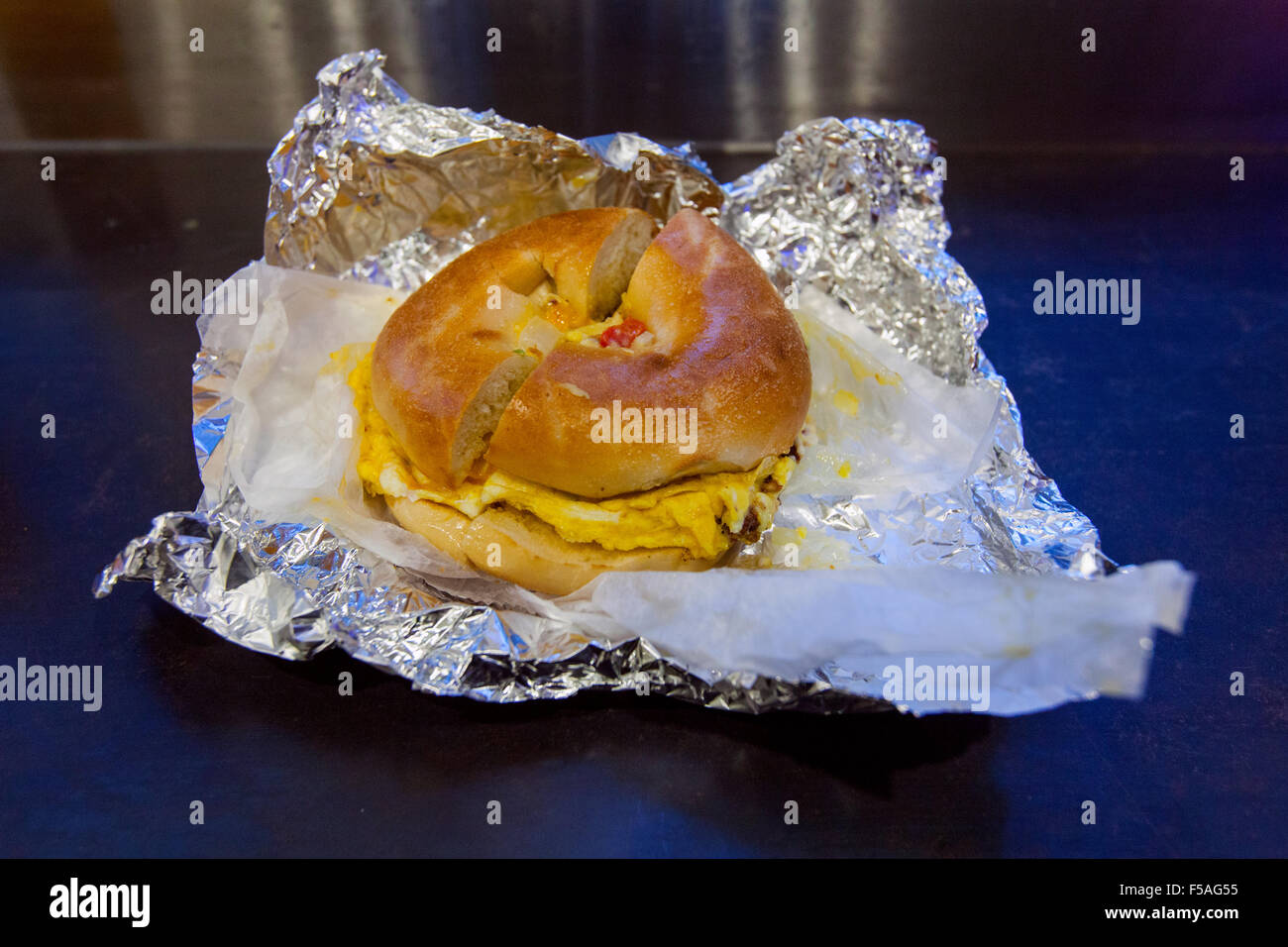 Spanish omelet in a toasted bagel at the Dali market delicatessen, 7th Avenue, Manhattan, New York City,America. Stock Photo