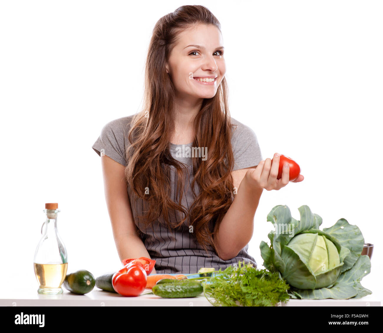 Young Woman Cooking in the kitchen. Healthy Food - Vegetable Salad. Diet. Dieting Concept. Healthy Lifestyle. Cooking At Home. P Stock Photo