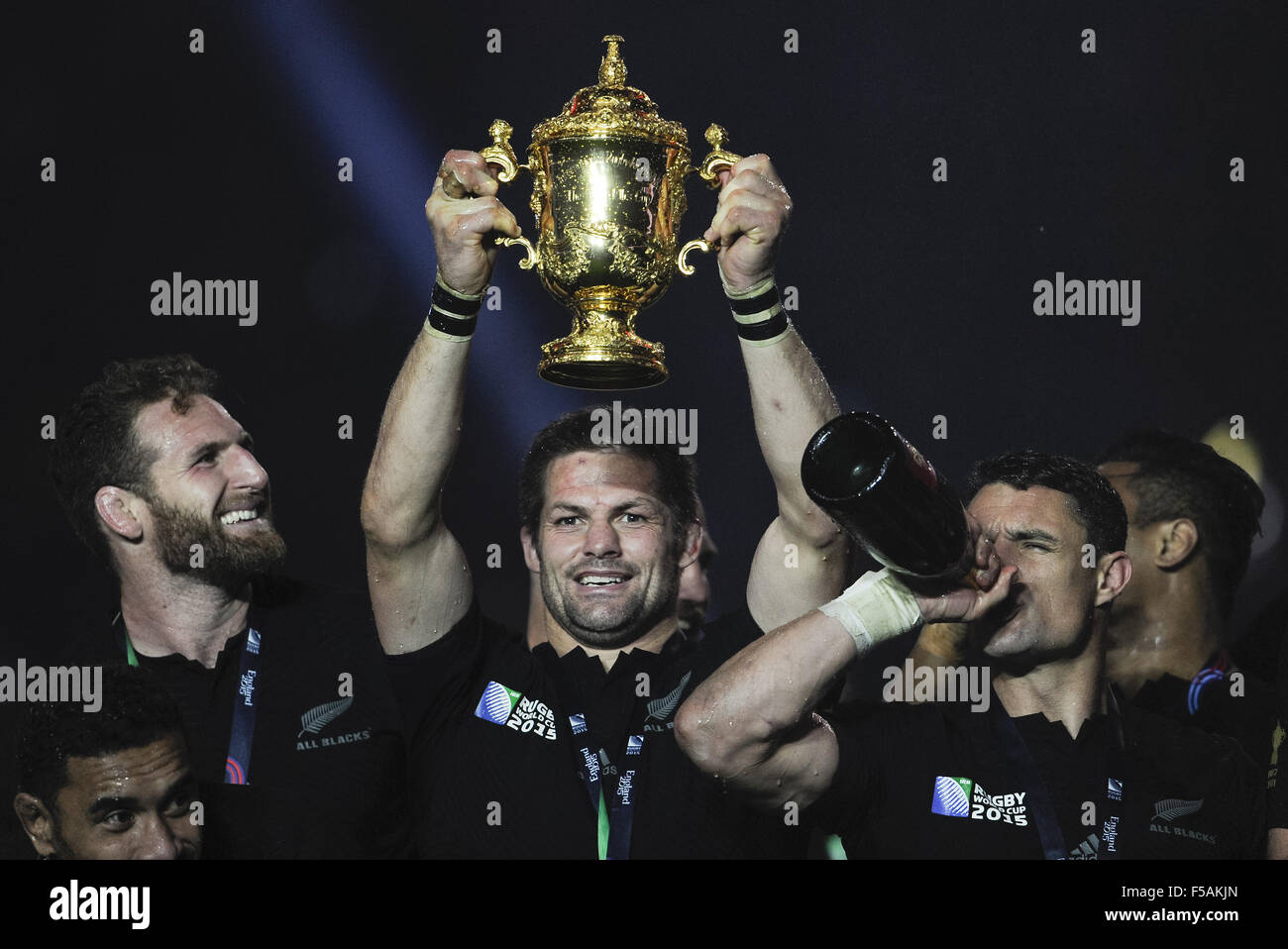 London, UK. 31st Oct, 2015. LONDON - OCTOBER 31: New Zealand's Richie McCaw lifts the Webb Ellis Trophy as Kieran Read looks on and Dan Carter enjoys the champagne after New Zealand defeats Australia 34-17 at the 2015 Rugby World cup Championship match at Twickenham Stadium in London. Photo Credit: Bigshots Photo.Credit: Andrew Patron/Zuma Wire © Andrew Patron/ZUMA Wire/Alamy Live News Stock Photo