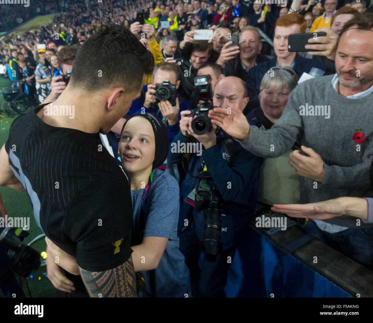 Twickenham, London, UK. 31st Oct, 2015. Rugby World Cup Final. New Zealand versus Australia. A young fan invades the pitch and drags off New Zealand replacement back Sonny Bill Williams into the crowd with him Credit:  Action Plus Sports/Alamy Live News Stock Photo
