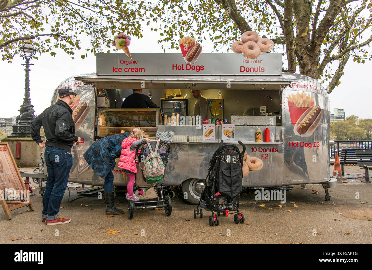 Family waiting to be served outside Airstream Cafe hot dog and ice cream van on the South Bank Stock Photo