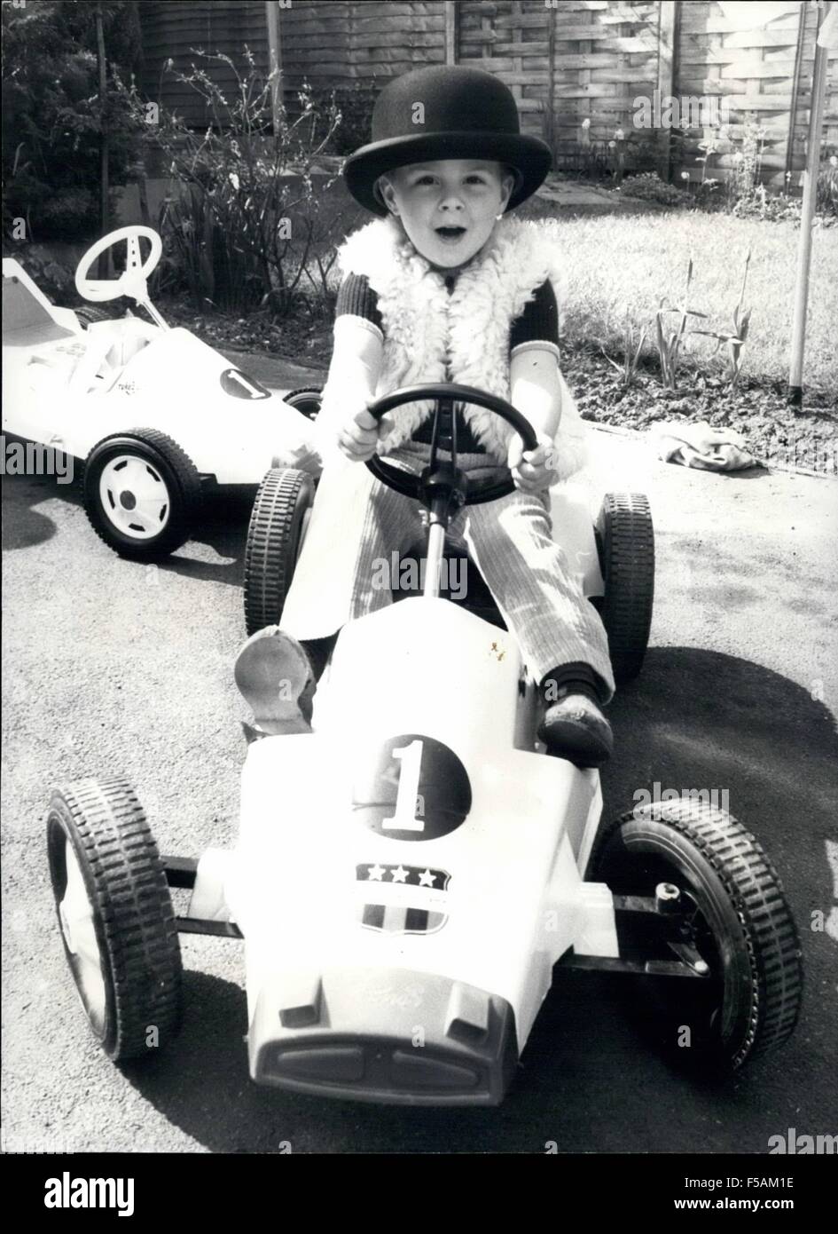 1968 - The Soft Sell From the 3 year old Tycoon.: ''No time to stop, I have some important clients to see!'' and with a Roar of Revs. the bowler hatted Super Salesman as away, off for another day's successful business in his Turbo Jet Powered Company Car. 3 year old James zoom away at an incredible 4 MPH, round to the garage where he demonstrates his superb Salemanship. Tripping his Boweler hat at a dignified, authoratitive angle he points the attributes of the Canadian made Turbo Jet Car, powered with rechargeable Solid Gel Batteries.''Look, No pedals'' he say's as he careers round the garden Stock Photo