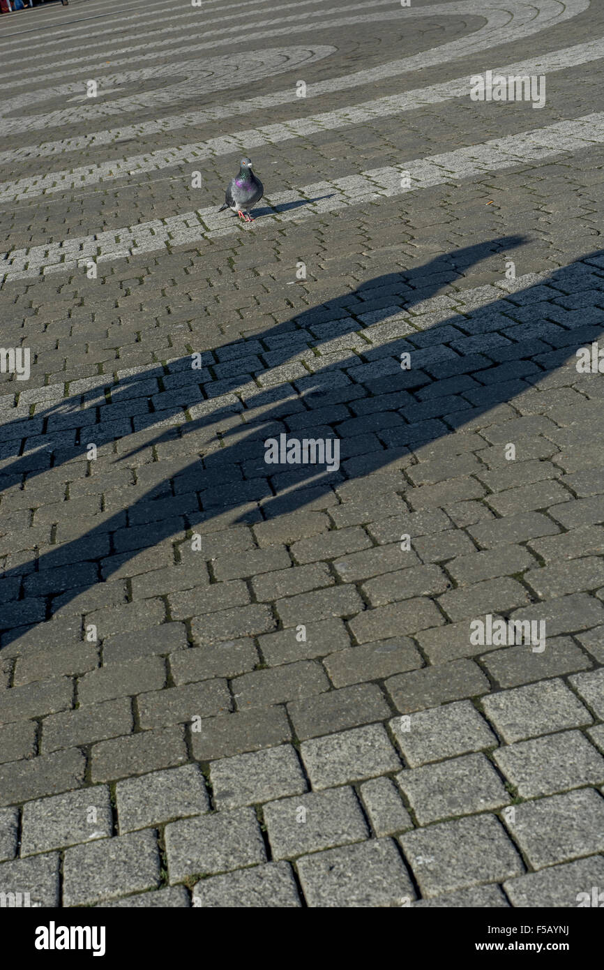 Cobbled pedestrian walkway surface in Truro, Cornwall with people shadows. Metaphor high street decline, footfall decline, shadow economy. Stock Photo