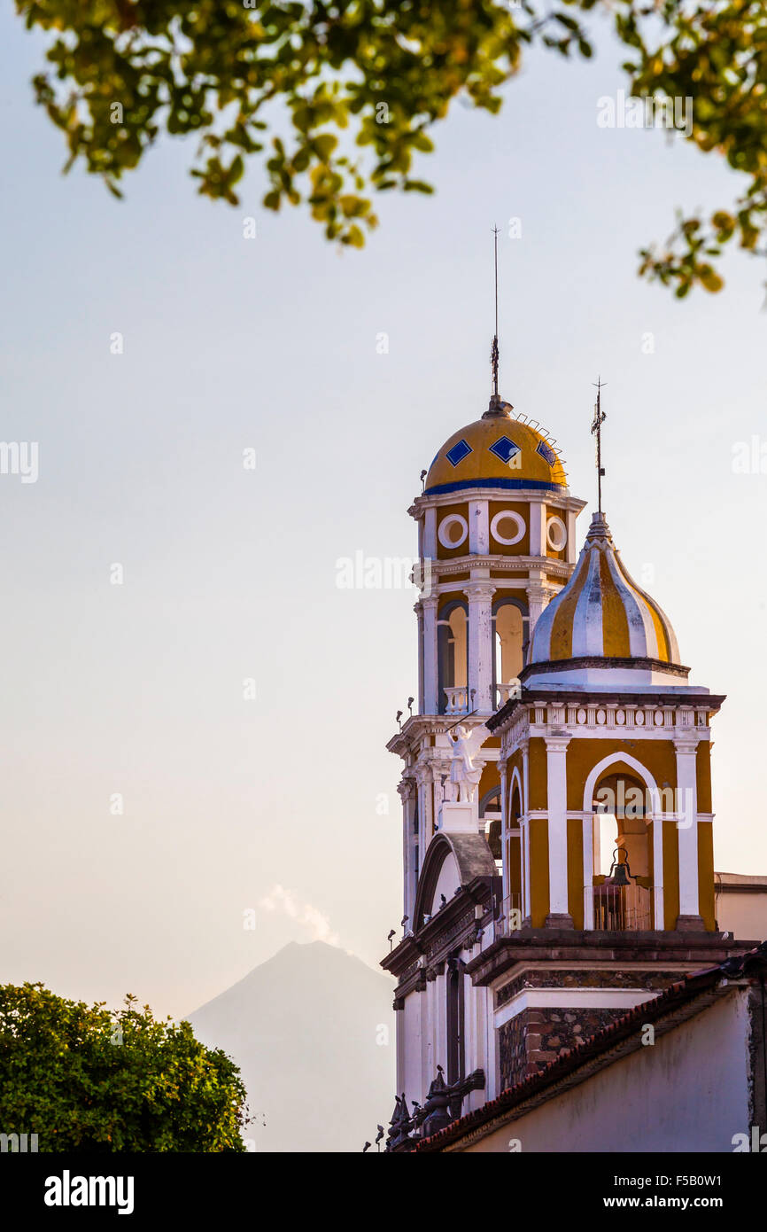 Church towers with the Volcan del Fuego in the background, Comala, Colima, Mexico. Stock Photo