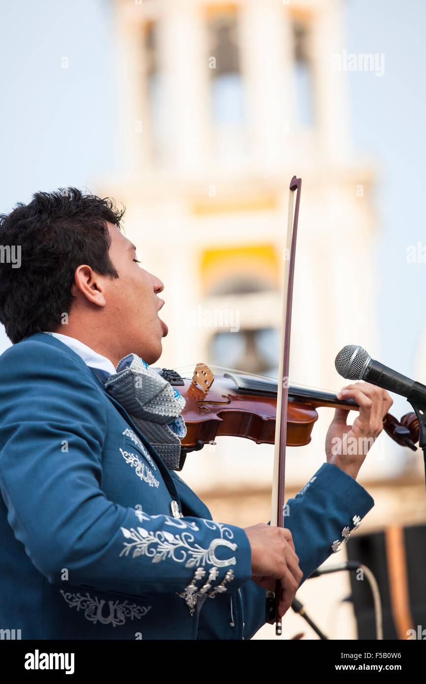 A mariachi musician sings to a crowd in the plaza of Comala, Colima, Mexico. Stock Photo