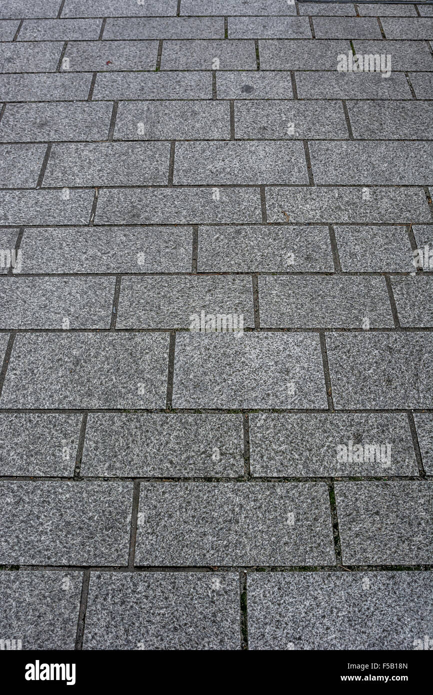Granite pavement blockwork in Cambourne, Cornwall. Metaphor high street decline, footfall decline. Stock Photo