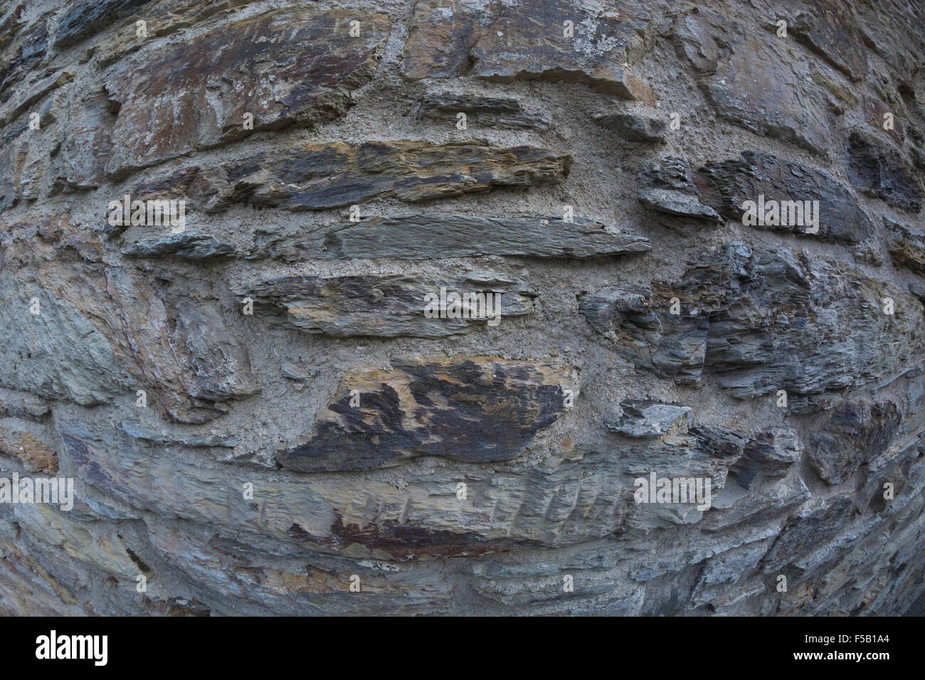 Distorted fisheye close-up shot of stone wall. Metaphor distorted view of life. Stock Photo