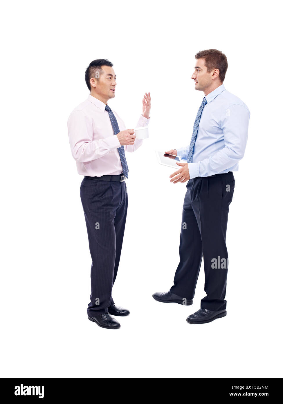 asian and caucasian corporate executives standing and talking Stock Photo