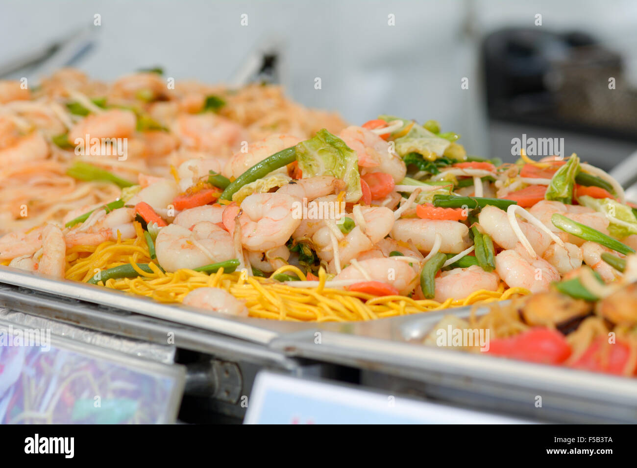Row of dishes on hot plates at Chinese food stall at annual Plymouth Food Festival in Devon