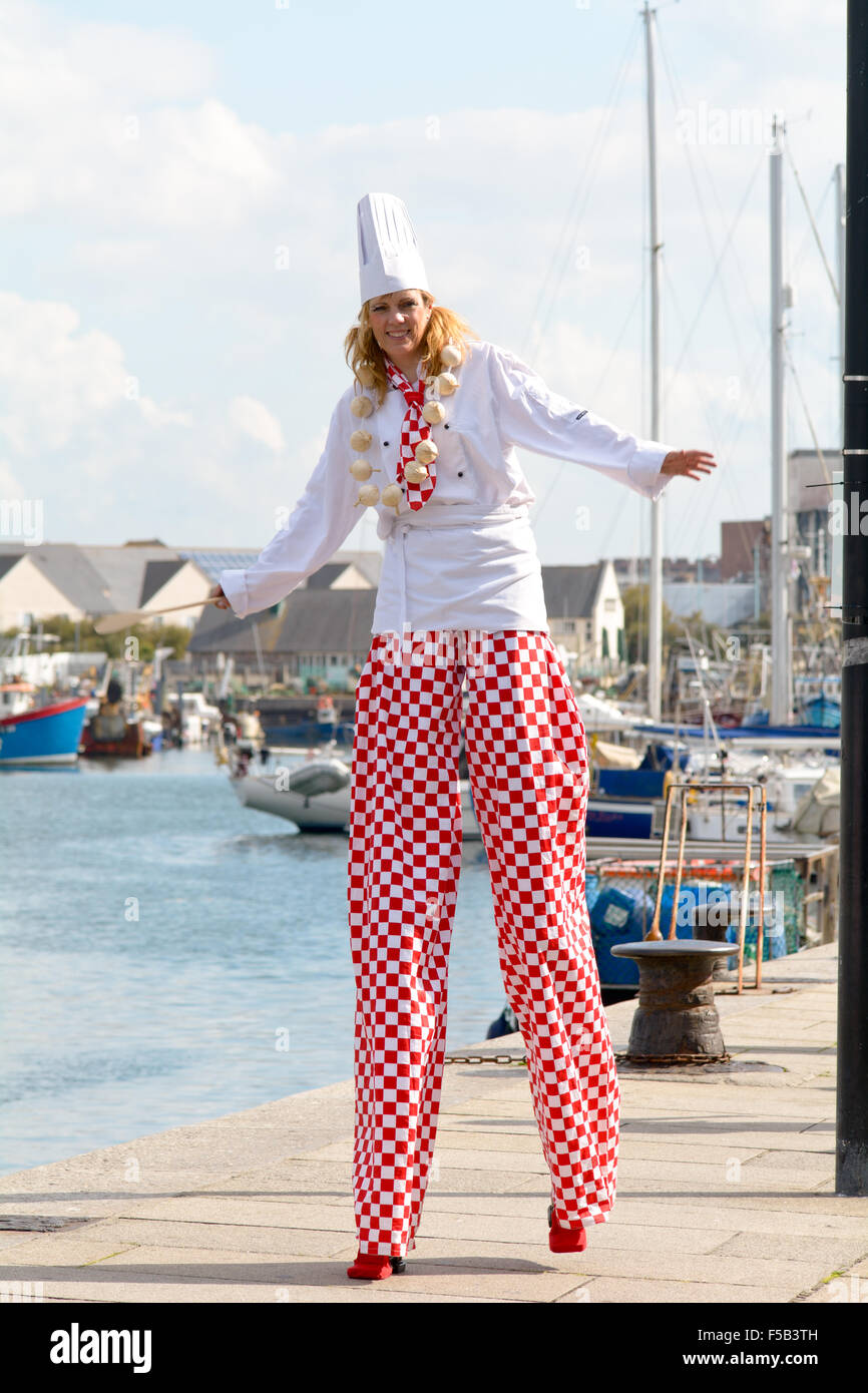 Stilt walker dressed as a chef in Sutton Harbour at Plymouth Food