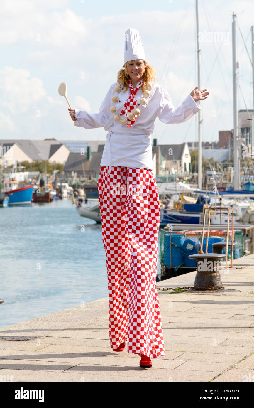 Stilt walker dressed as a chef in Sutton Harbour at Plymouth Food