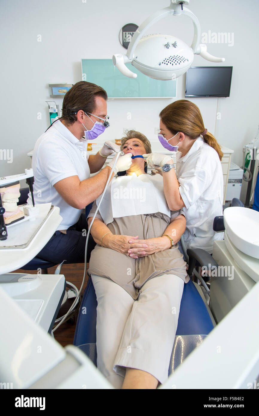 Dentist office, dentist, assistant and older patient, dental treatment