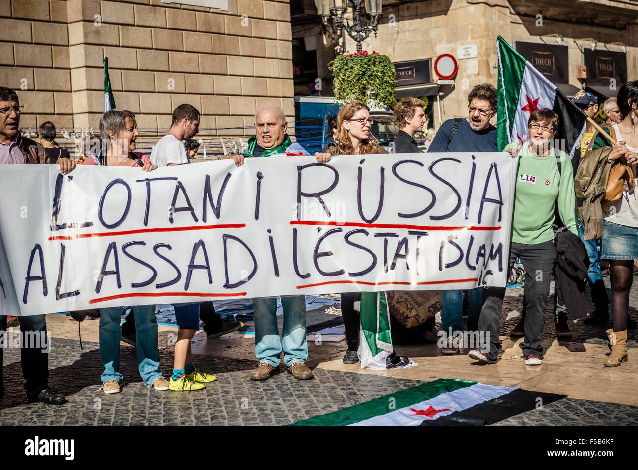 October 31st, 2015. Barcelona, Spain: Pro-palestine demonstrators protest behind their banner in Barcelona to against the NATO, Russia, Assad and the ISIS. Stock Photo