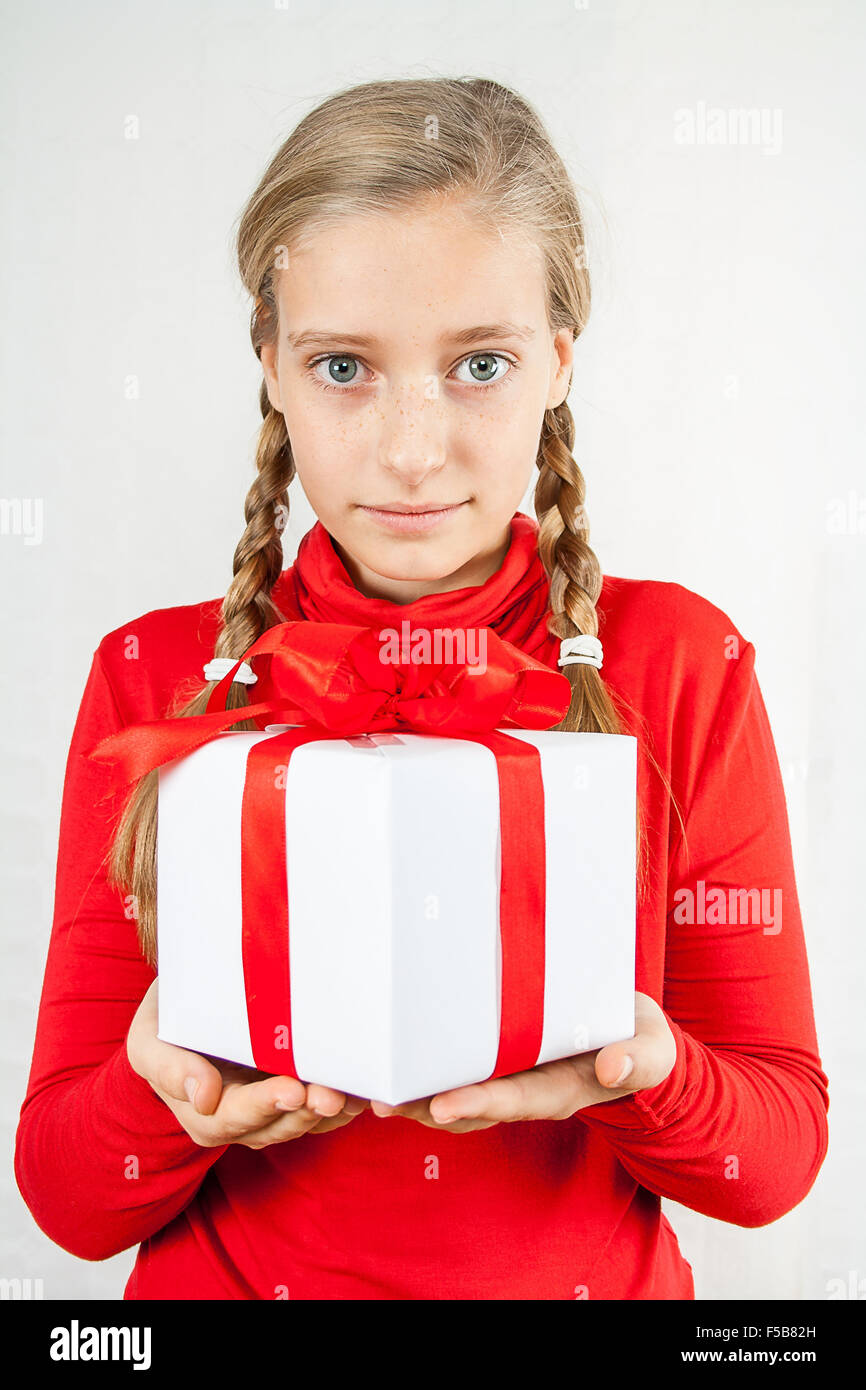 Cute blond teenage girl in red with gift box Stock Photo