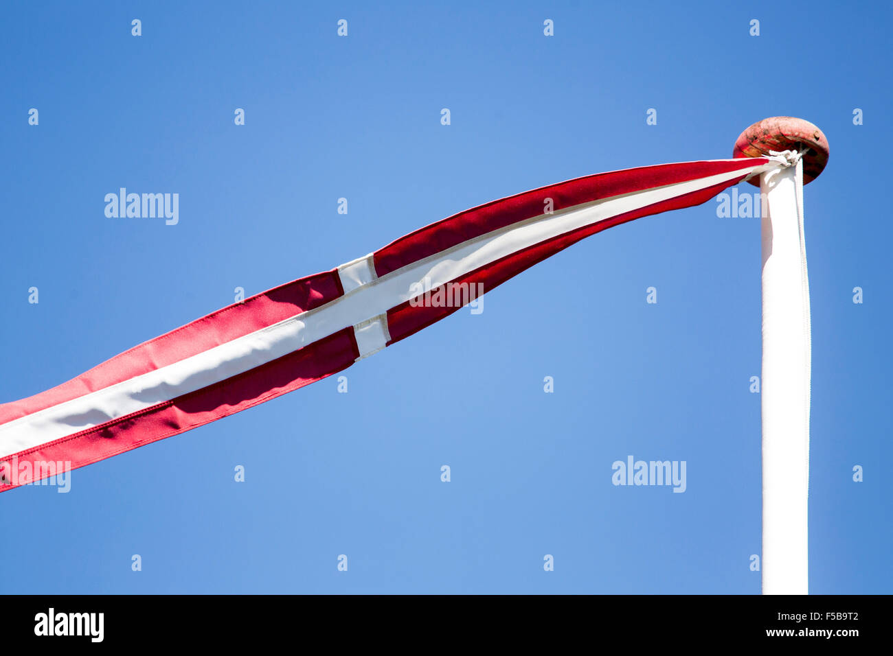 Danish pennant flag or vimpel flying against a clear blue sky Stock Photo