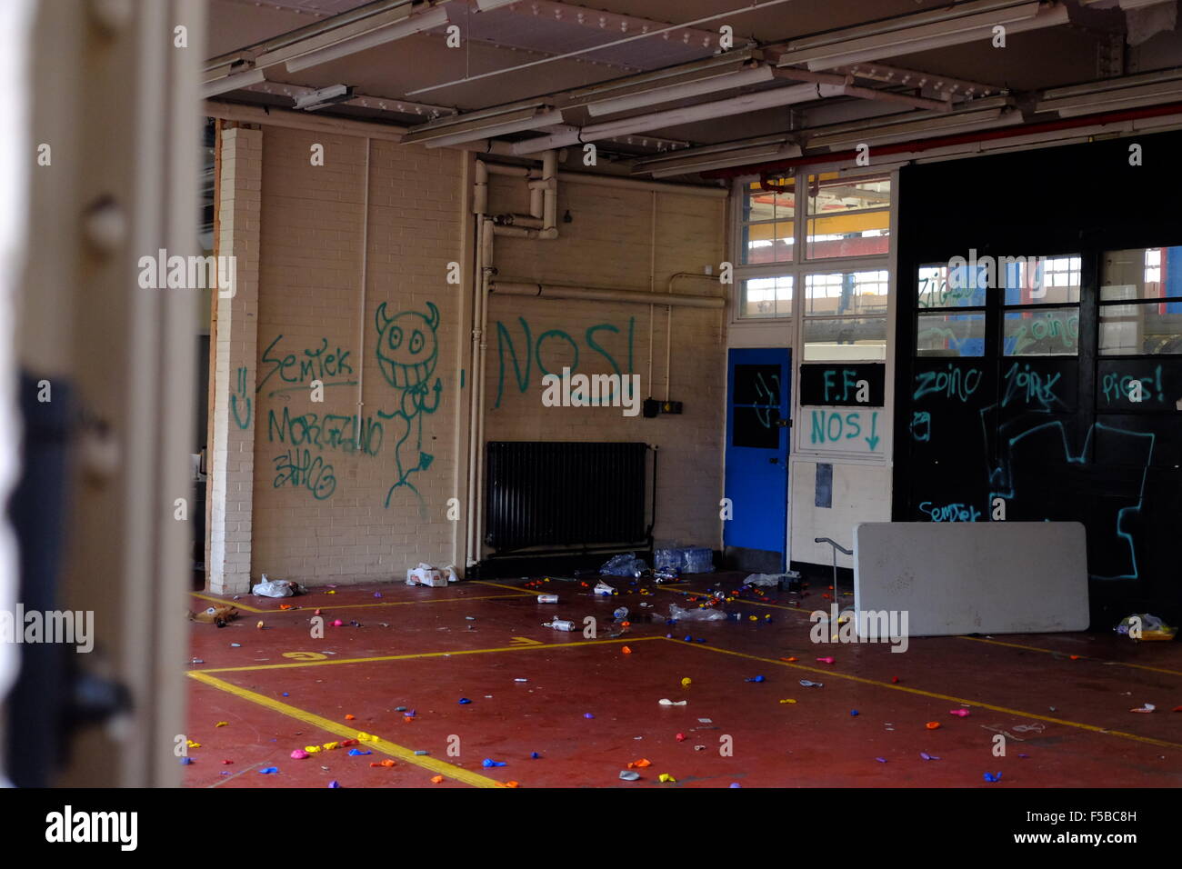 Inside the Rave location the morning after showing Nitrous oxide balloons and graffitti Stock Photo