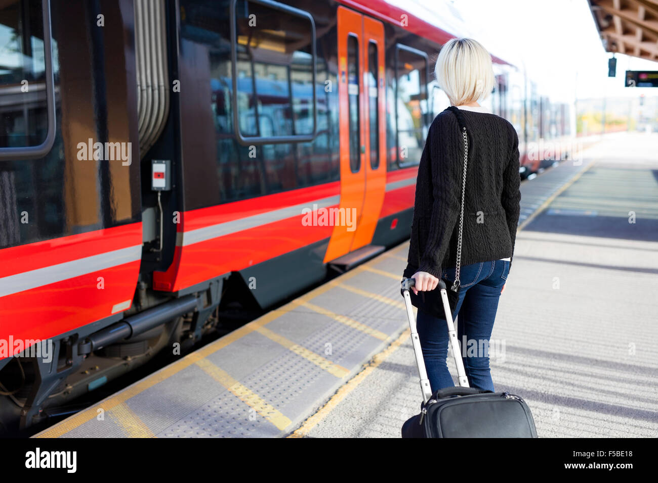 Young woman at a outdoor train terminal Stock Photo - Alamy