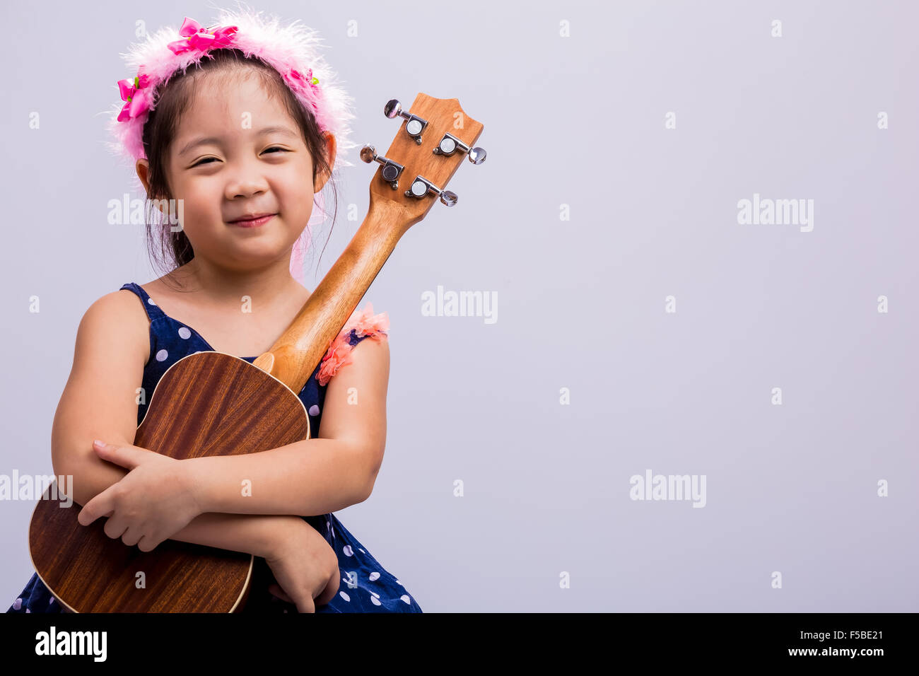Little girl with her ukulele, string music instrument Stock Photo Alamy