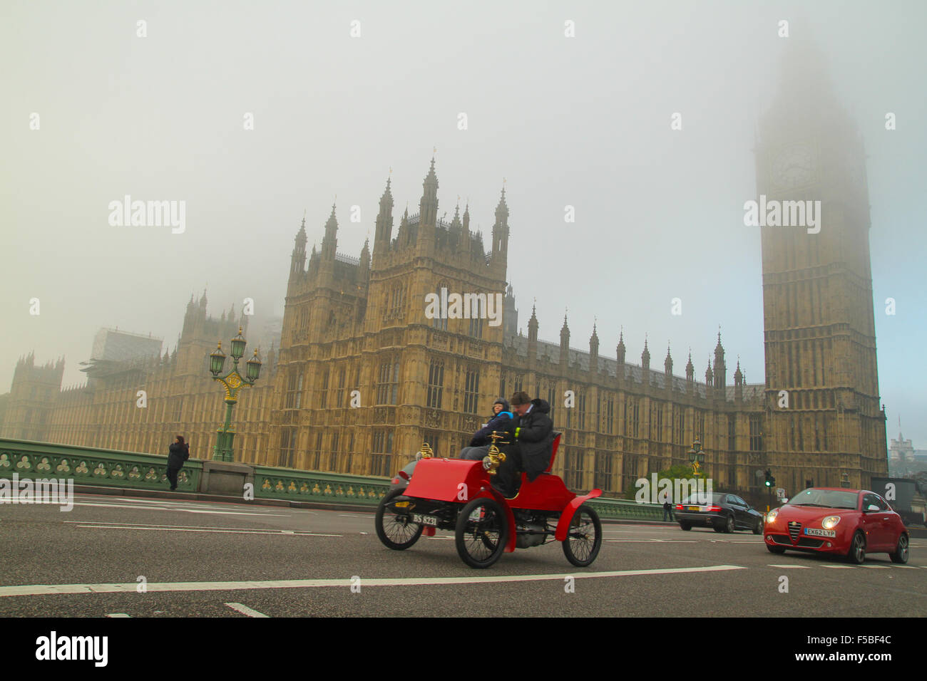 London, UK. 01 November 2015. A red vintage car speeds past Westminster