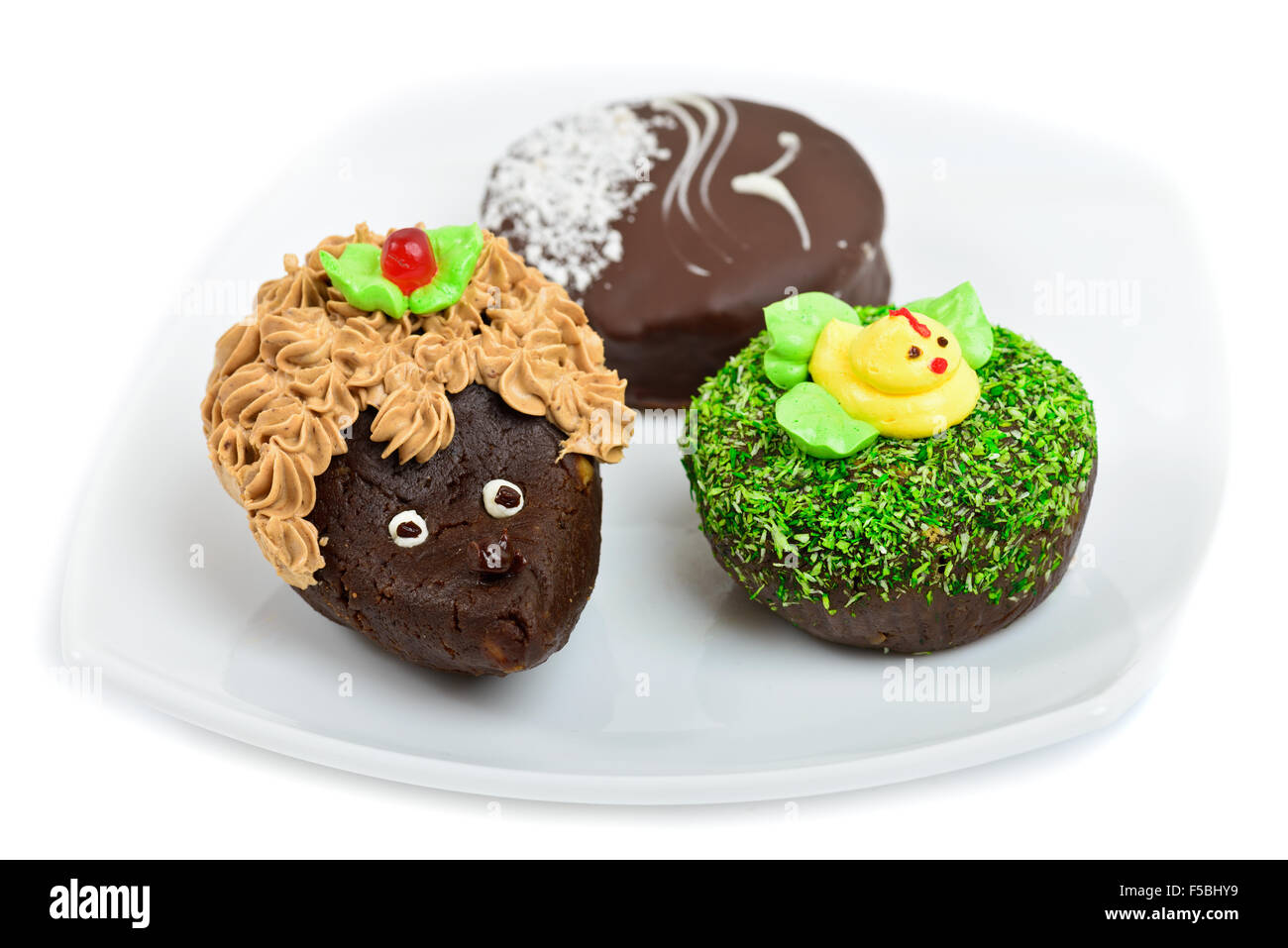 Artistic chocolate cakes decorated as hedgehog, duck and seagull Stock Photo