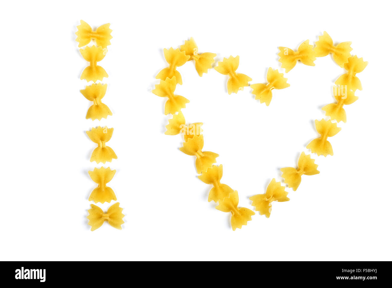 pasta farfalle arranged heart shape isolated on white Stock Photo