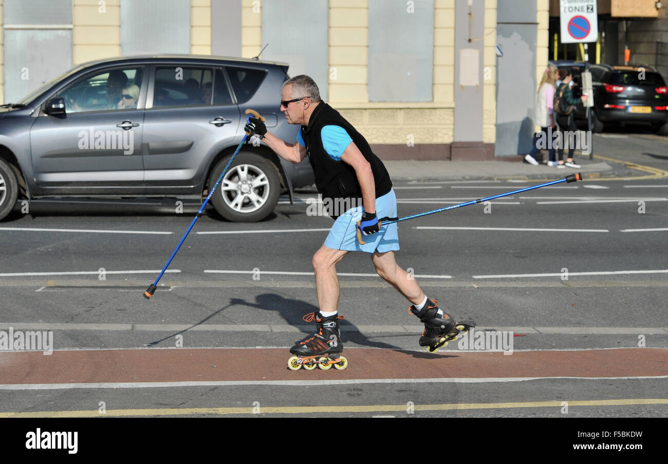 Brighton Sussex UK 1st November 2015 - This chap speeds along a cycle lane as people make the most of the unusually warm sunny weather on Brighton beach and seafront today Stock Photo