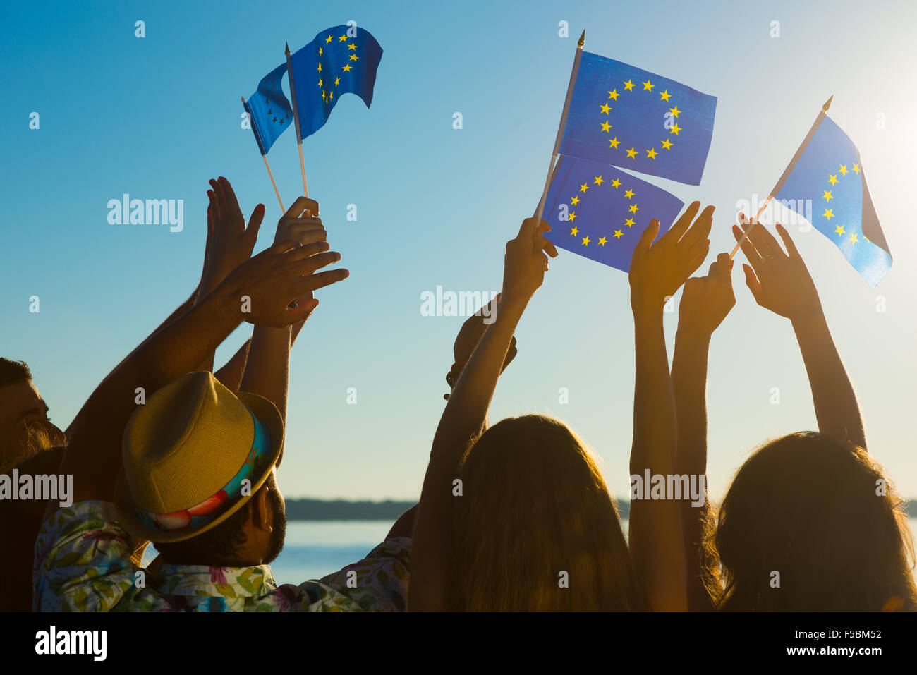 People with raised hands waving flags of the European Union Stock Photo ...