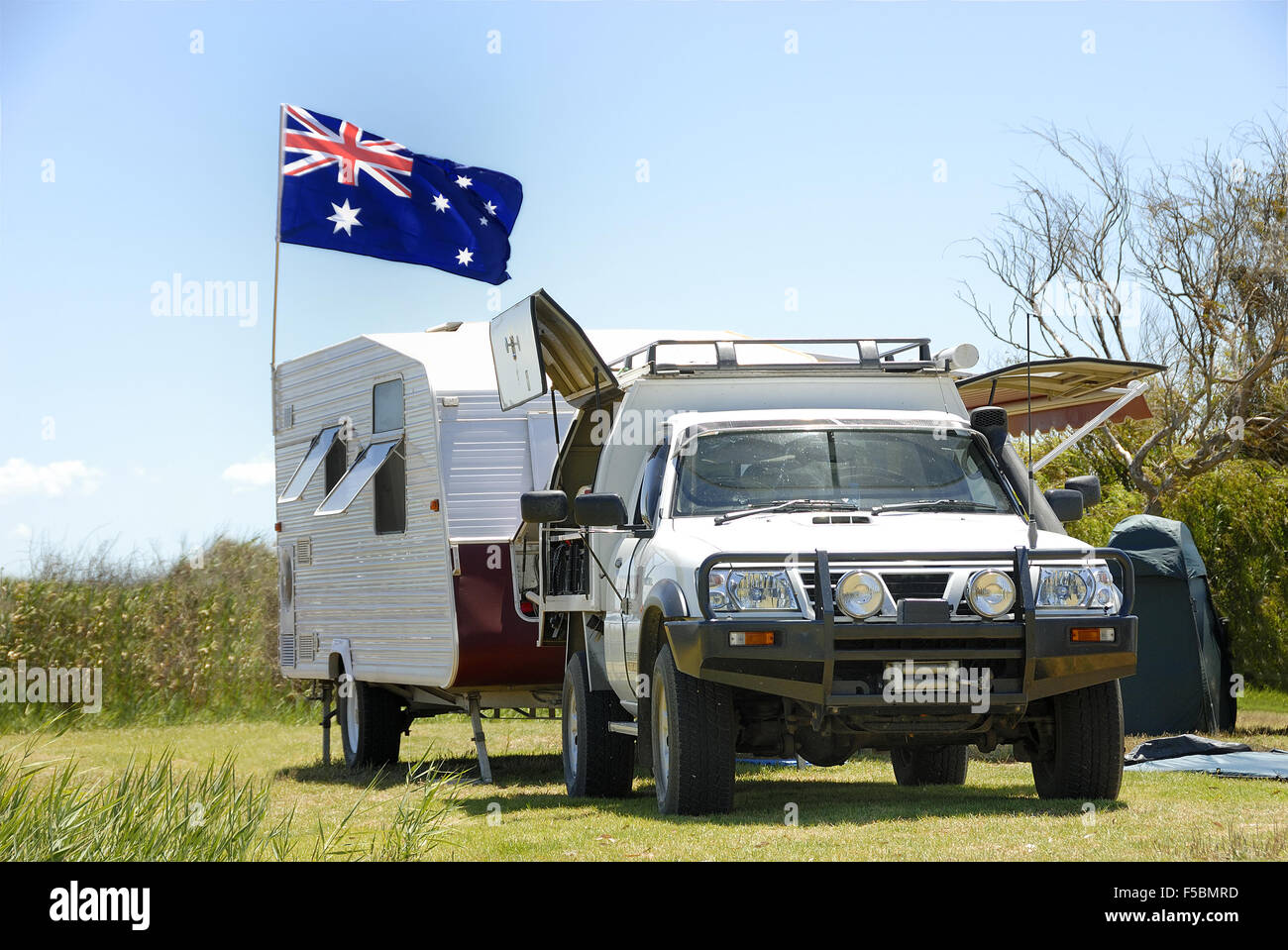 Camping in Australia with caravan and Australian national flag Stock Photo Alamy