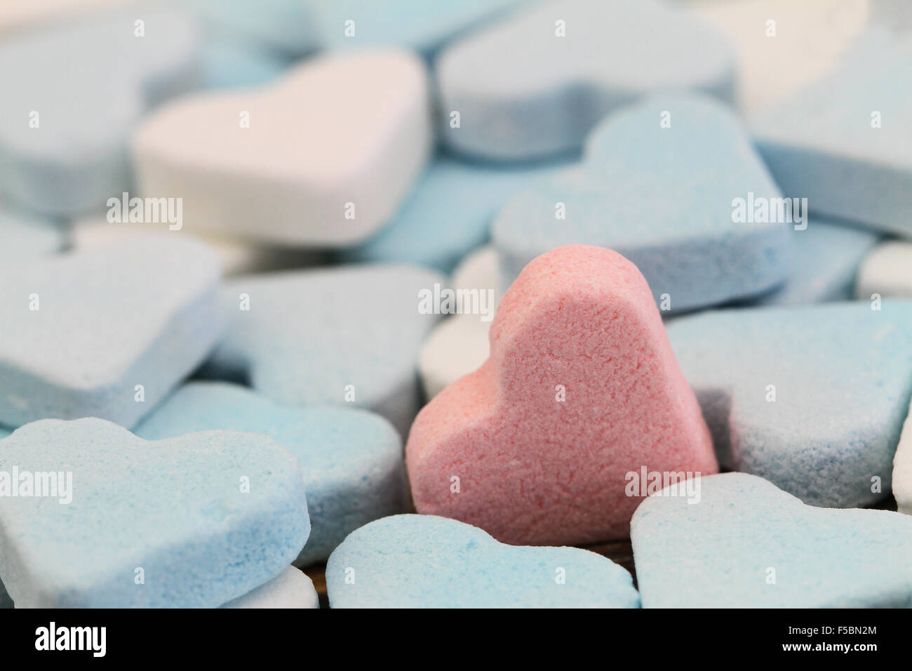 Pink sugar heart among white and blue sugar hearts Stock Photo