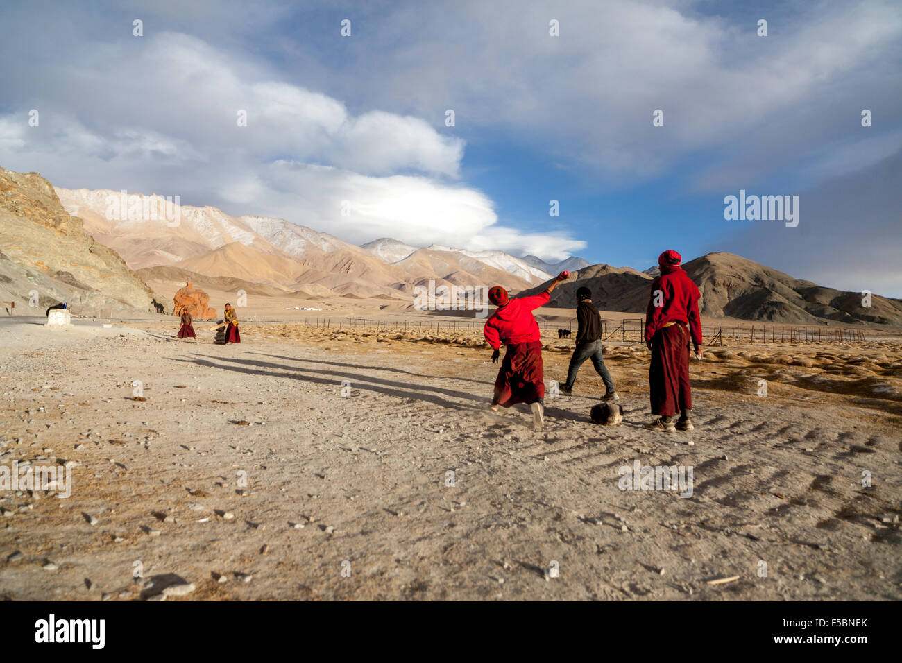 The monks from the Hanle monastery playing a friendly game of cricket in the cold Ladakhi winter. Stock Photo