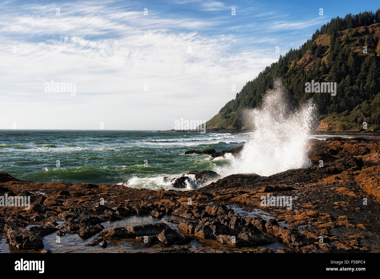 Waves break against the rocky shoreline of Oregon's Cape Perpetua Scenic Area. Stock Photo