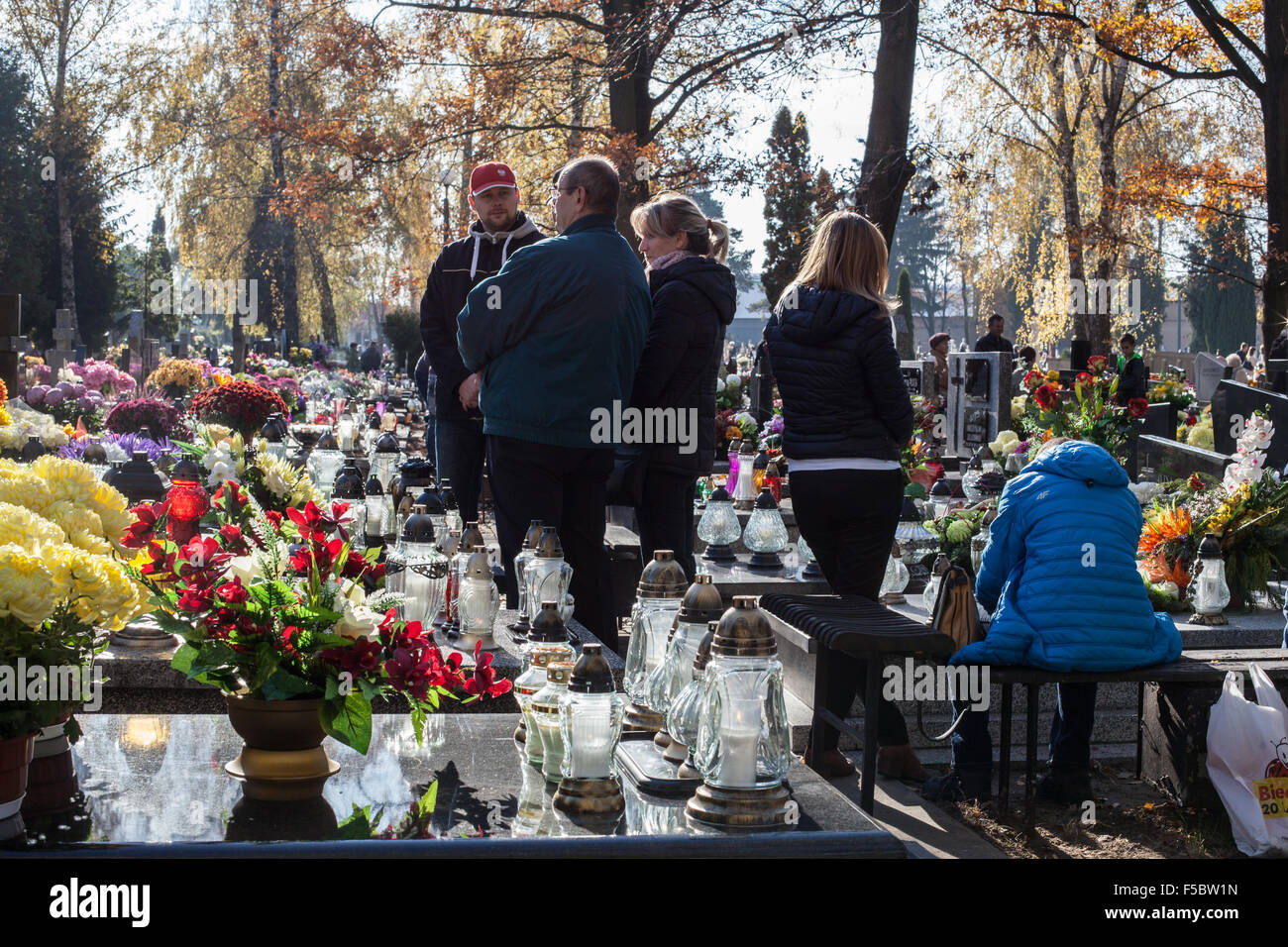 All Soul's Day in Poland on the 1st of November 2015. All Soul's Day is an important holyday in Poland. Many people gather in cemeteries to give respect to their loved ones who are already dead. Visitors light lights and bring flowers with them. Stock Photo