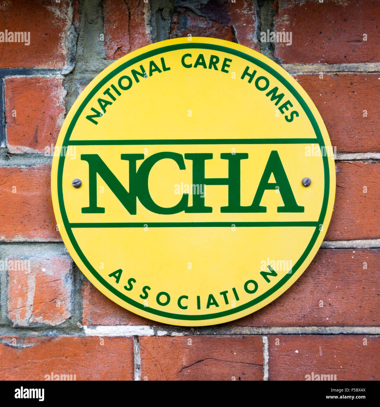 A NCHA National Care Homes Association sign on the wall of a residential care home in England. Stock Photo