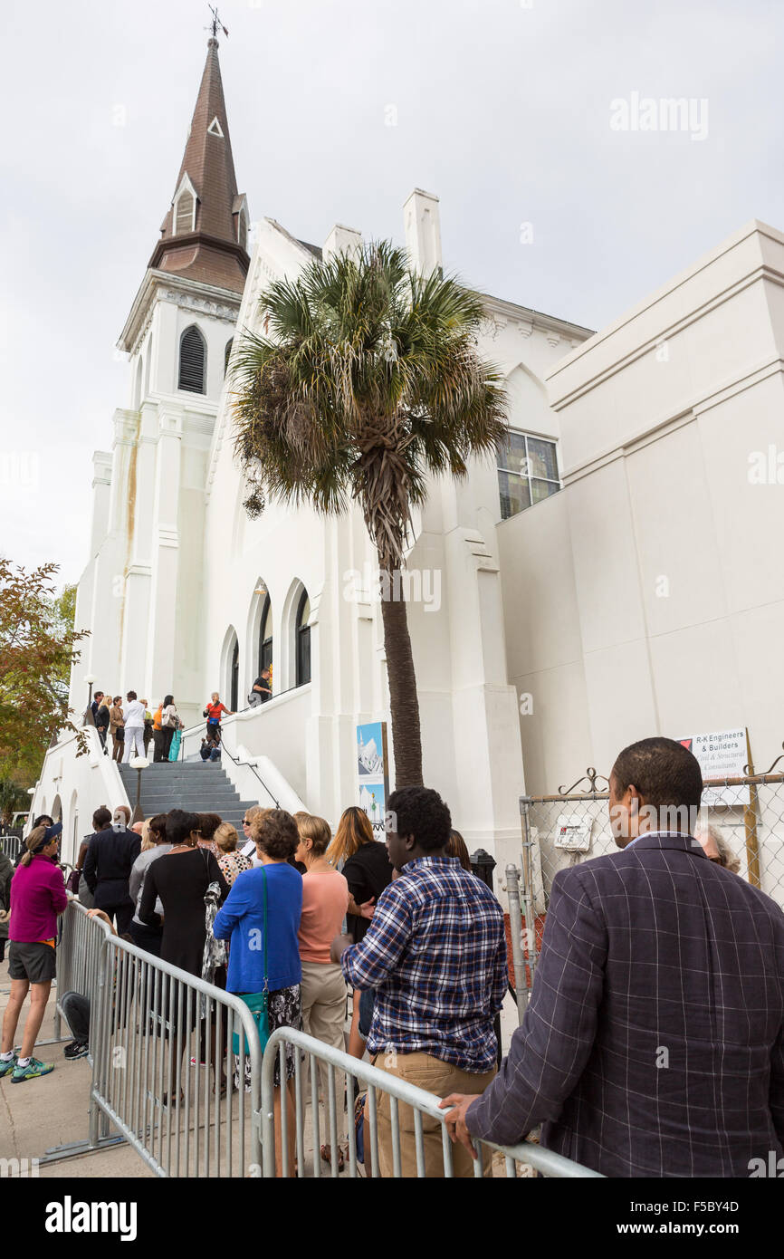 People line up outside the historic Mother Emanuel AME Church to hear superstar Pharrell Williams perform with the Gospel Choir during Sunday service November 1, 2015 in Charleston, South Carolina. The church was the site of the mass shooting that killed nine-people in June 2015 and will be featured as part of a program on race relations being produced by A+E Networks. Stock Photo