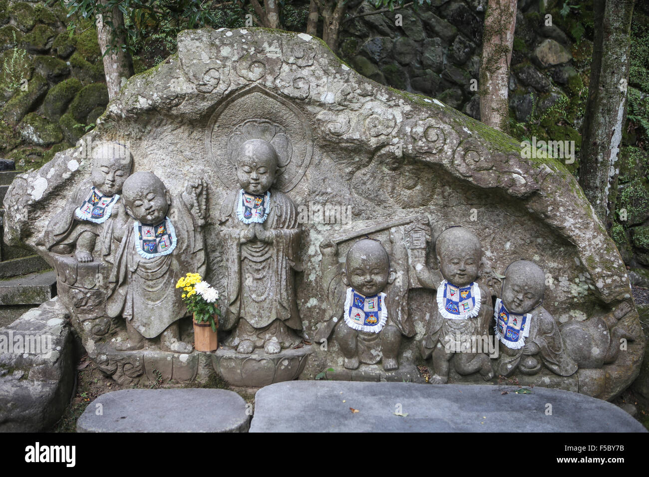 Baby buddha stone statue with bibs on mount kurama Stock Photo