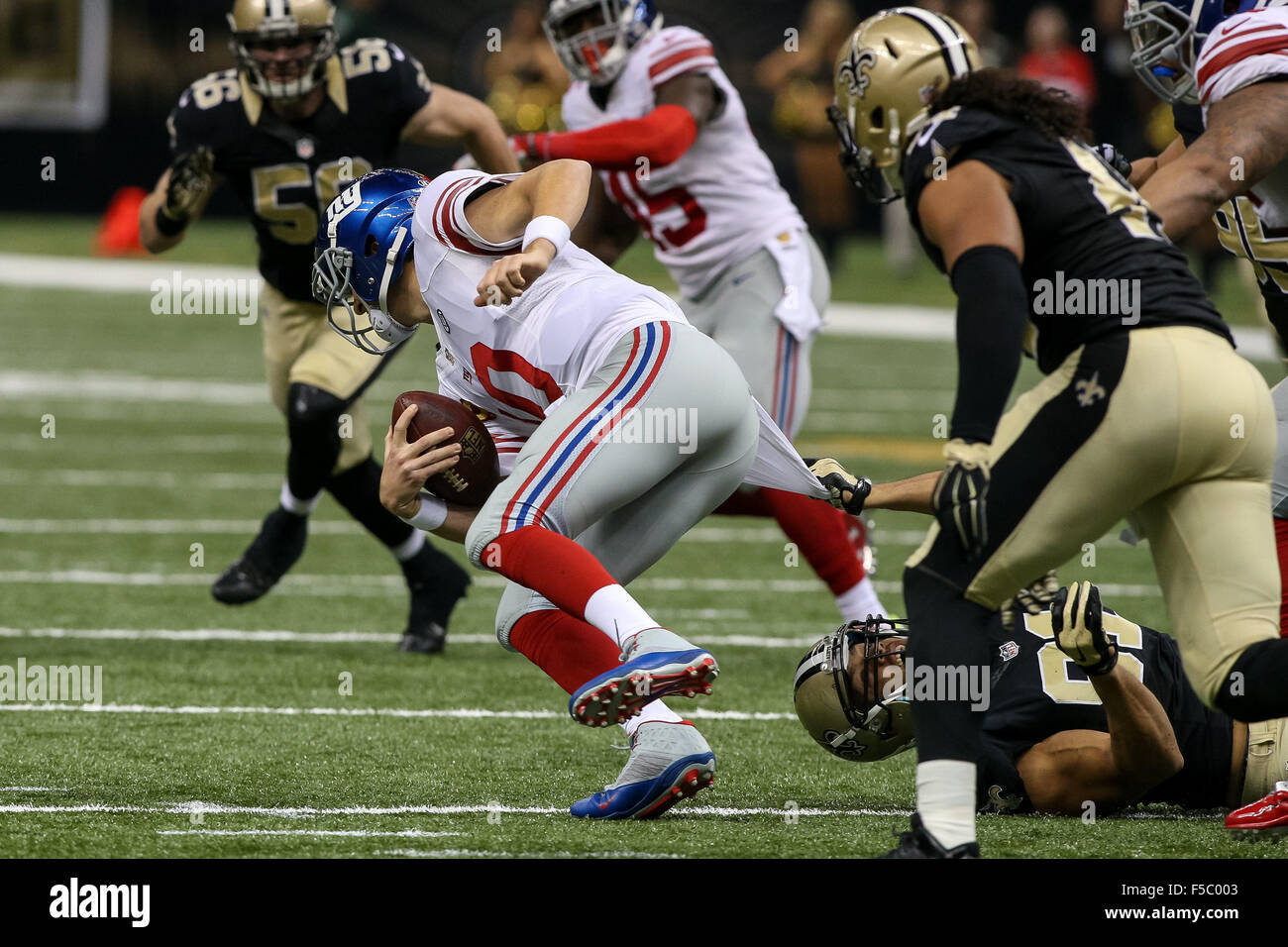 November 1, 2015 - New York Giants quarterback Eli Manning (10) is sacked by New Orleans Saints outside linebacker Kasim Edebali (91) during the game between the New Orleans Saints and the New York Giants at the Mercedes-Benz Superdome in New Orleans, LA. Stephen Lew/CSM Stock Photo