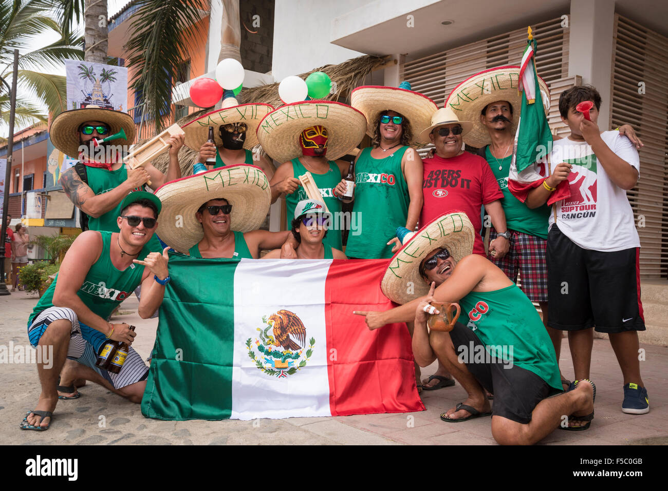 Supporters of the Mexican Stand Up Paddleboarding team during the World Cup in Sayulita, Riviera Nayarit, Mexico. Stock Photo