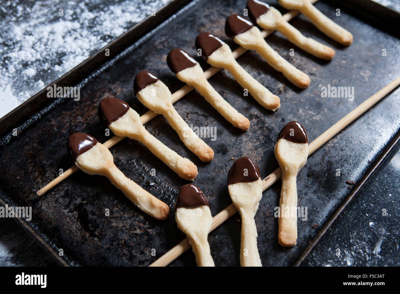 Two Rows of Cookie Spoons Dipped in Chocolate Stock Photo