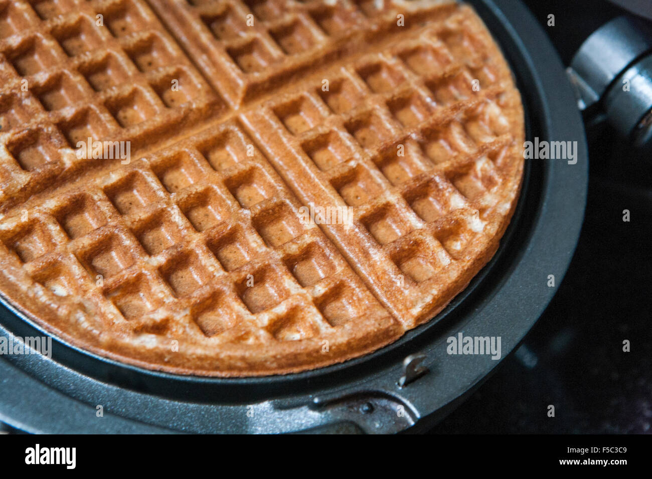 Waffle and Waffle Iron, Close-Up Stock Photo