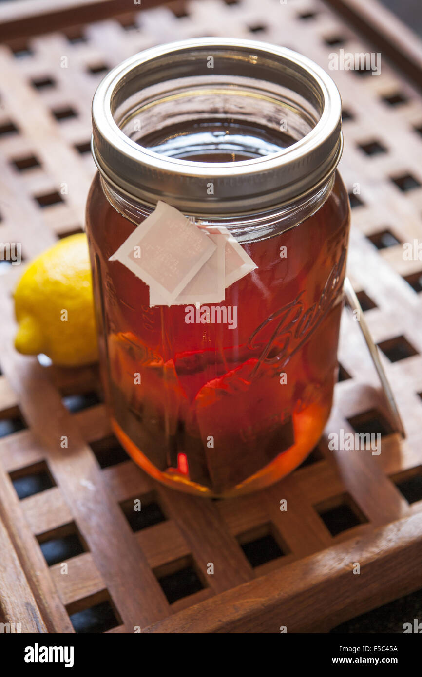 Iced Tea Being Brewed in Glass Jar with Teabags, Lemon Stock Photo Alamy