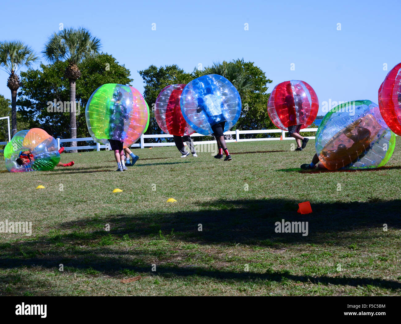 Group of people playing bubble ball soccer Stock Photo