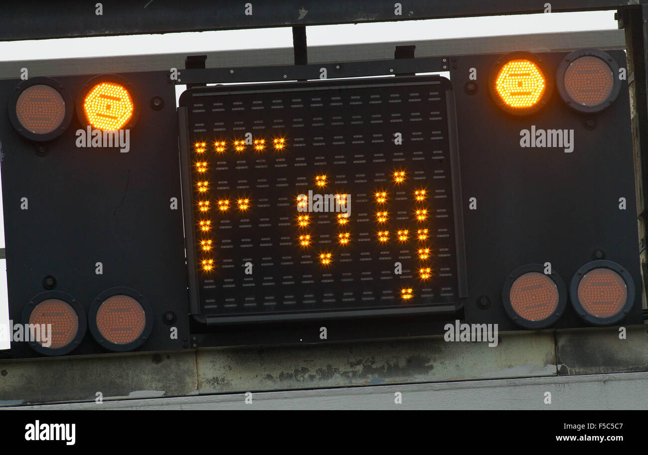 An illuminated motorway matrix sign which reads 'FOG' on the A12, East London. Stock Photo