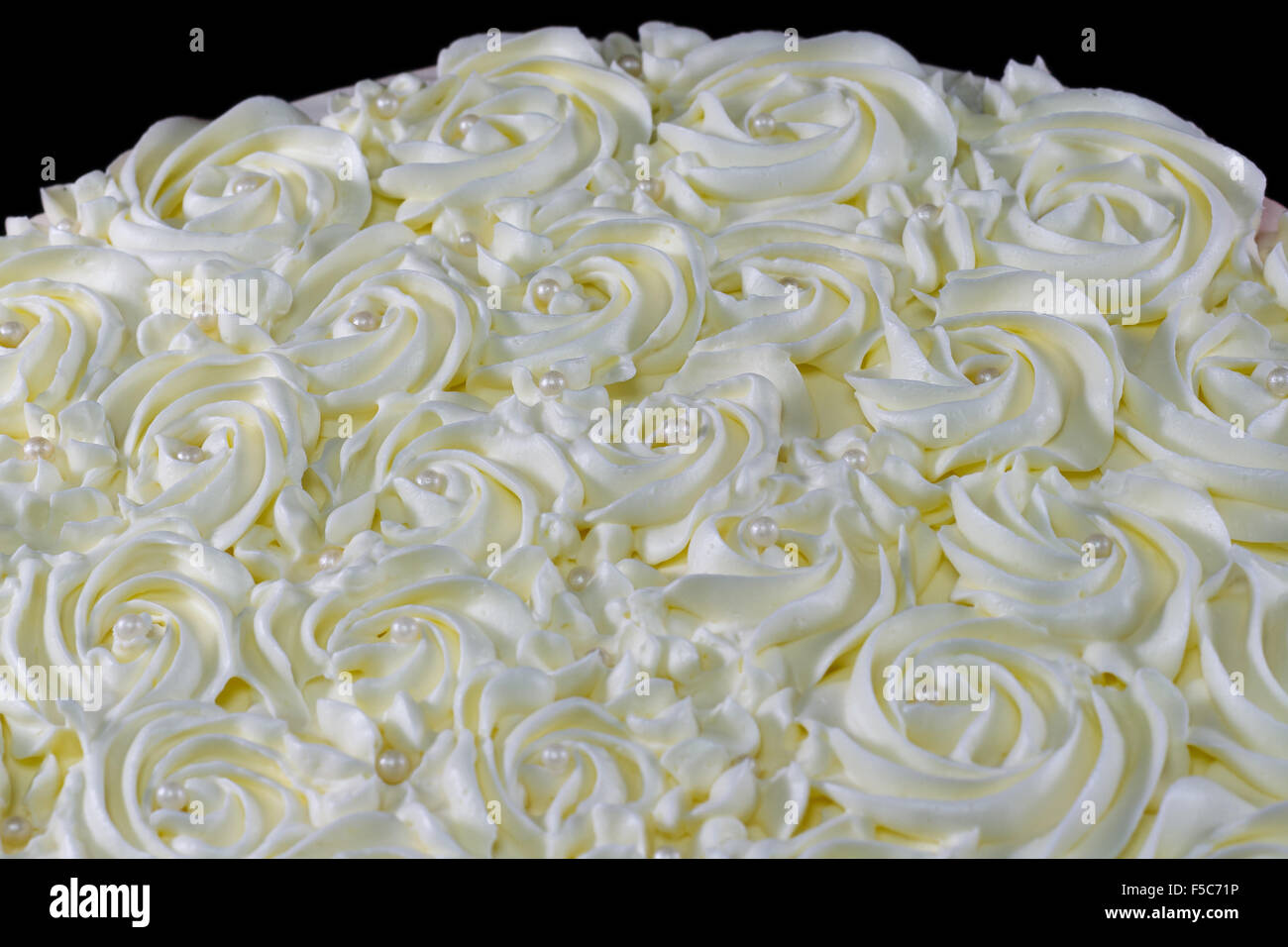 Close-up of buttercream icing and pearls on top of a cake Stock Photo