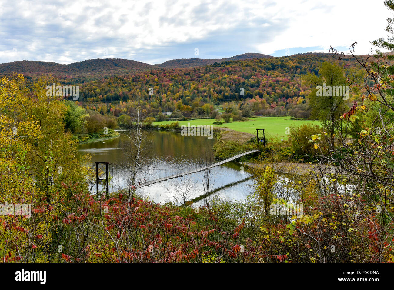 Winooski River Footbridge in Vermont during peak foliage in autumn. Stock Photo