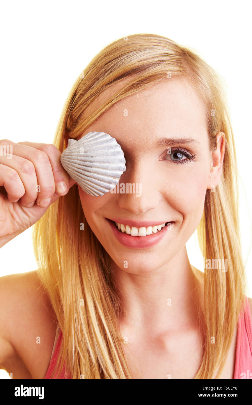 Young happy woman holding a cockle in her hand Stock Photo